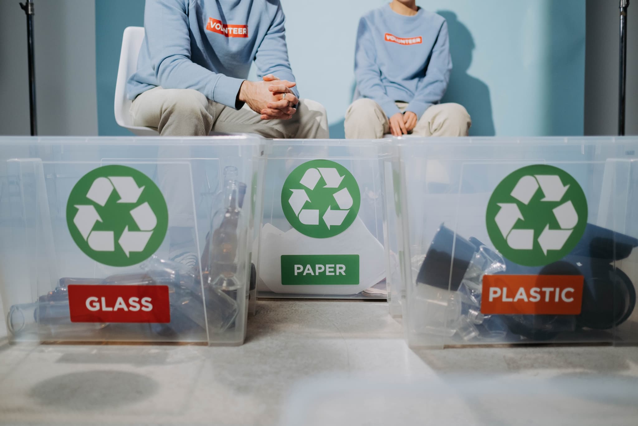 Recycling boxes with two persons sitting